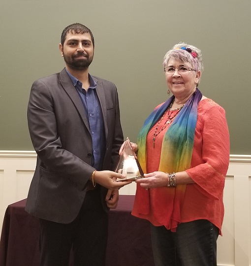 2019 Volunteer of the Year Leanne Van Wagner receiving award from Trijesh Thakur - Servus Credit Union